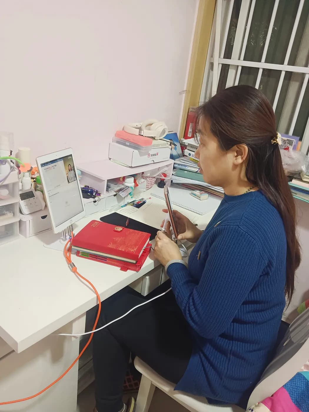A video call on a tablet, with working notes alongside